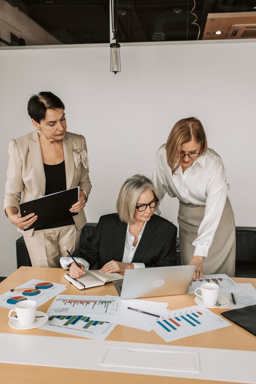 Professionals reviewing charts and data at a table